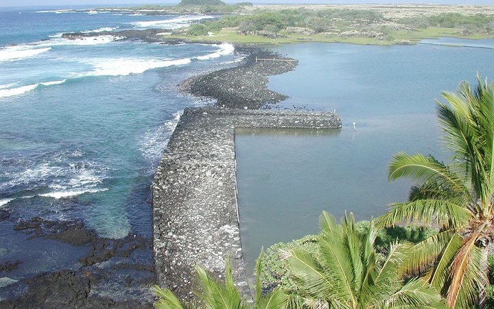 Historic volcanic-rock fishpond wall and turquoise Pacific surf at Kaloko-Honokōhau near Kailua-Kona, Hawaii