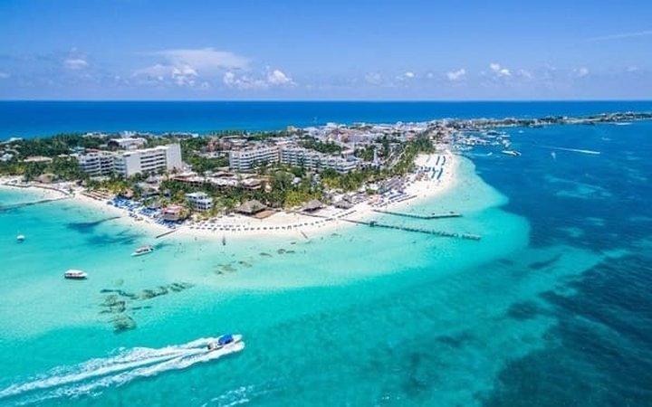 Aerial view of turquoise Caribbean water and beach resorts for a January escape