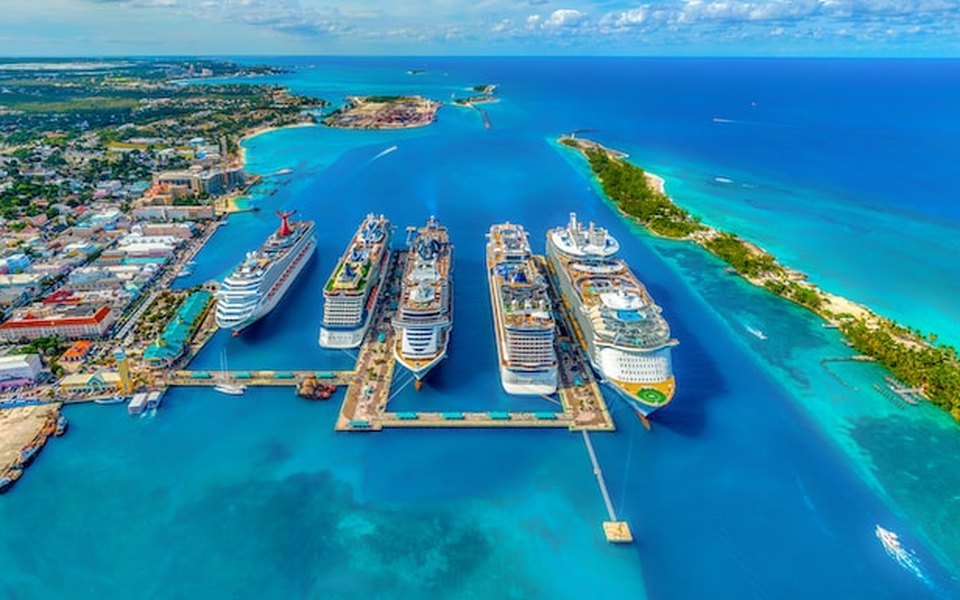 Aerial view of cruise ships docked in turquoise water at Nassau harbour for international January flight deals from Toronto